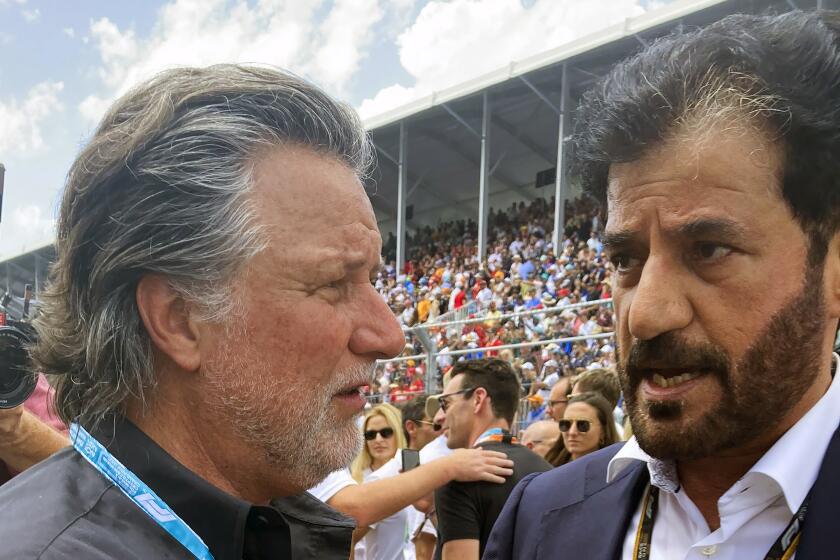 FILE - Michael Andretti, left, talks with FIA President Mohammed bin Sulayem before the Formula One Miami Grand Prix auto race at Miami International Autodrome, Sunday, May 8, 2022, in Miami Gardens, Fla. The FIA on Monday, Oct. 2, 2023, said Michael Andretti meets all required criteria to field a future Formula One team. Monday's announcement was a first — but important — step in Andretti's three-year quest to return one of racing's most storied names to the pinnacle of motorsports. (AP Photo/Jenna Fryer, File)