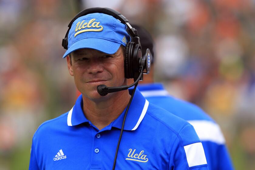 UCLA Coach Jim Mora watches his team play against Virginia on Saturday.