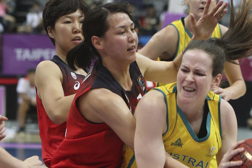 Australia''s Keely Jane Froling (11), right, and Japan''s Mamiko Tanaka (12) fight for a loose ball