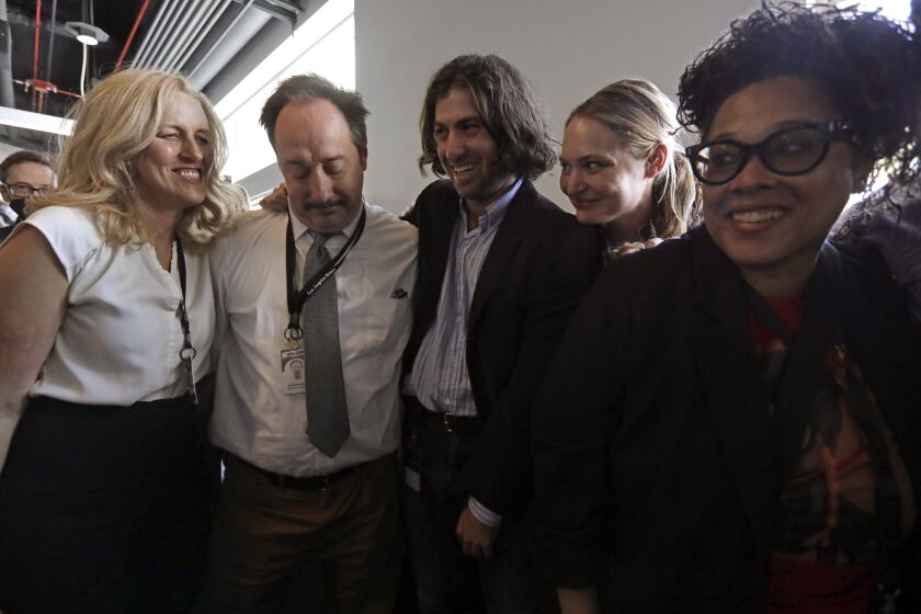 EL SEGUNDO, CA - MAY 8, 2023 - Los Angeles Times reporters Dakota Smith, from left, David Zahniser, Ben Orestes, Julia Wick Los Angeles columnist Erika D. Smith celebrate after winning the Pulitzer Prize Breaking News Reporting at the Los Angeles Times in El Segundo on May 8, 2023. Staff of the Los Angeles Times revealed a secretly recorded conversation among city officials that included racist comments, followed by coverage of the rapidly resulting turmoil and deeply reported pieces that delved further into the racial issues affecting local politics. (Genaro Molina/Los Angeles Times)