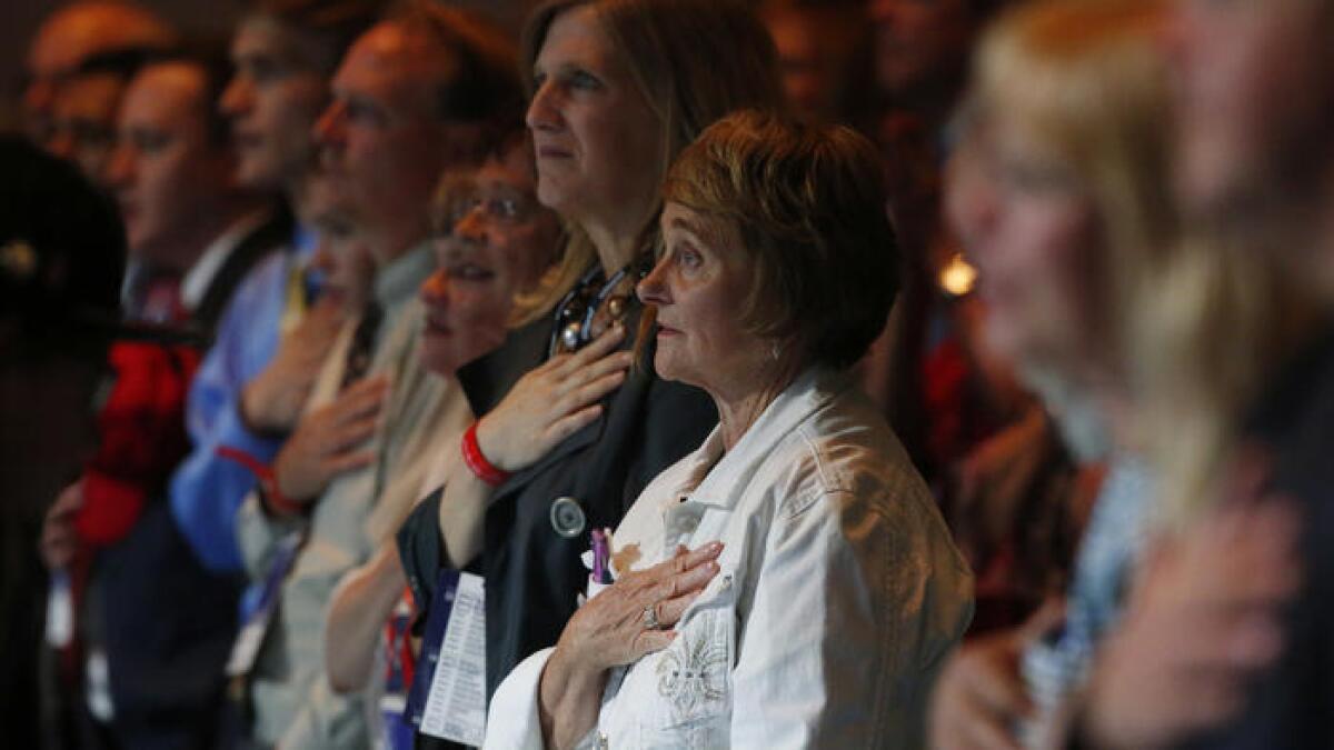 Participants stand to recite the Pledge of Allegiance at the Western Conservative Summit in Denver on Friday.