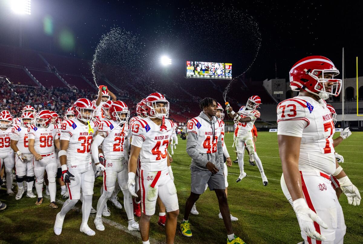Mater Dei teammates spray water in the air to celebrate their 35-7 win in Division 1 final.