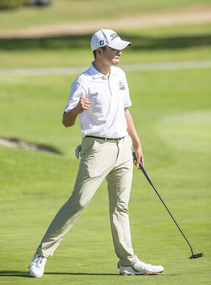 Corona del Mar's Colin Huang pumps his fist in celebration after birdieing the third hole during a Surf League match against Newport Harbor at Newport Beach Country Club on Thursday, April 18.