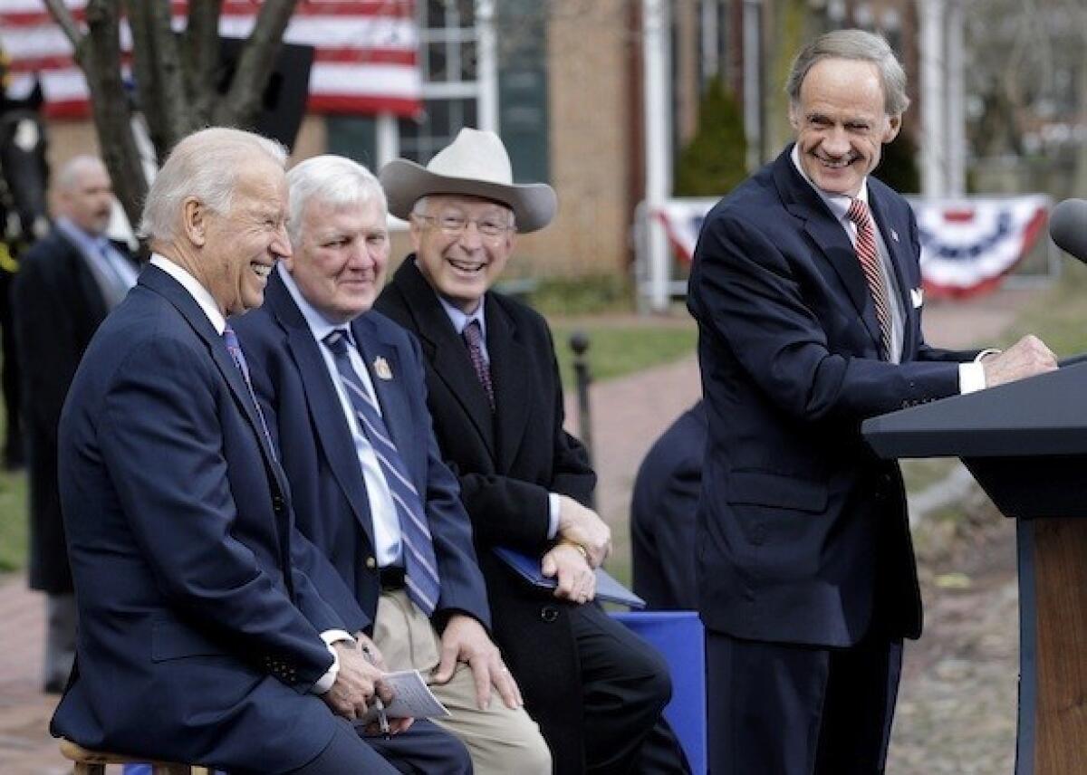 Sen. Tom Carper (D-Del.) right, speaks during a ceremony in New Castle, Del., on Tuesday at First State National Monument. Seated behind Carper, from left, are Vice President Joe Biden, New Castle Mayor Donald Reese and Interior Secretary Ken Salazar.