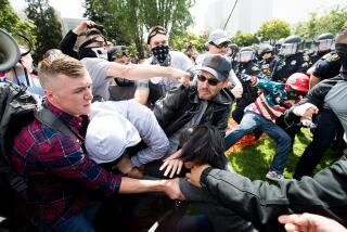 Protesters for and against President Donald Trump brawl on Saturday, April 15, 2017, in Berkeley, Calf.