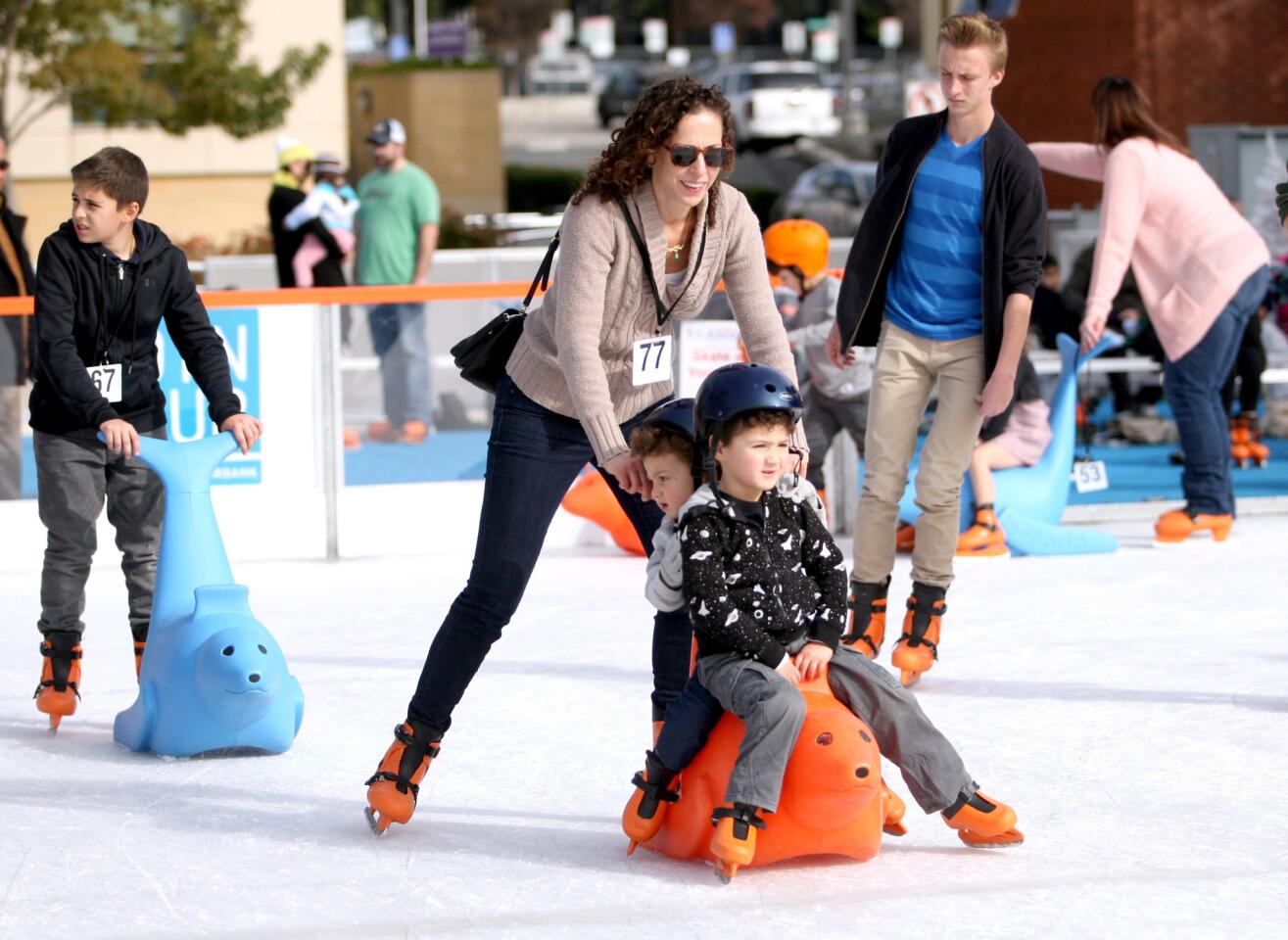 Deena Kashper, of Burbank, and her sons Teo, 5, and Luco, 2, enjoy a cool afternoon of ice skating at the The Rink in Downtown Burbank on Thursday, December 24, 2015. The rink, an Ice-America portable ice rink, is located in the City Hall parking lot on 3rd and Orange and will remain open until january 3rd.