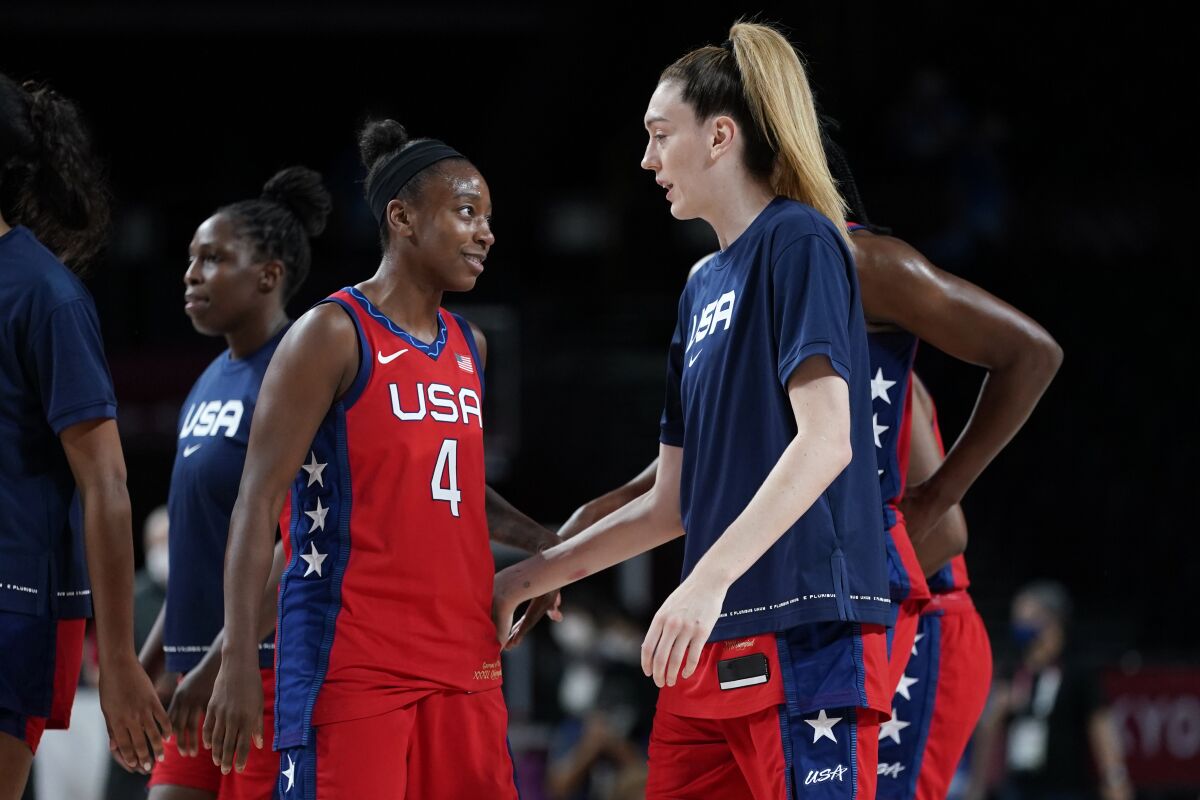 United States's Jewell Loyd (4) celebrates with teammate Breanna Stewart, right, at the end of a women's basketball quarterfinal round game against Australia at the 2020 Summer Olympics, Wednesday, Aug. 4, 2021, in Saitama, Japan. (AP Photo/Charlie Neibergall)