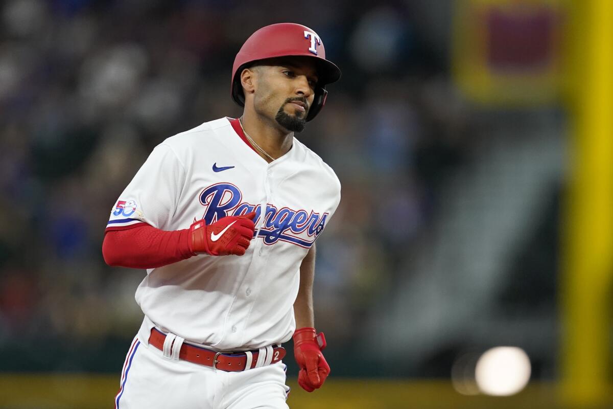 Texas Rangers' Marcus Semien rounds the bases after hitting a three-run home run in the fourth inning of a baseball game against the Minnesota Twins, Saturday, July 9, 2022, in Arlington, Texas. Leody Taveras and Charlie Culberson also scored on the play. (AP Photo/Tony Gutierrez)