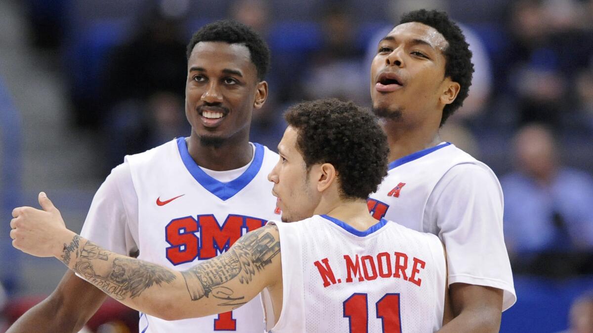 Southern Methodist's Ryan Manuel, from left, Nic Moore and Sterling Brown celebrate near the end of a 69-56 win over Temple in the Atlantic Coast Conference tournament semifinals on Saturday.