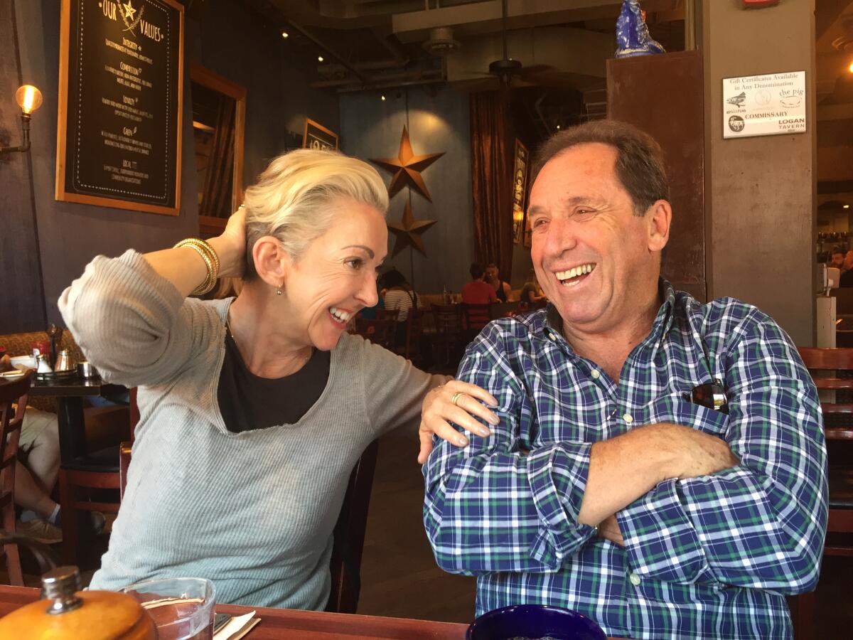 Jane and Raymond Wurwand laugh as they sit at a local restaurant.