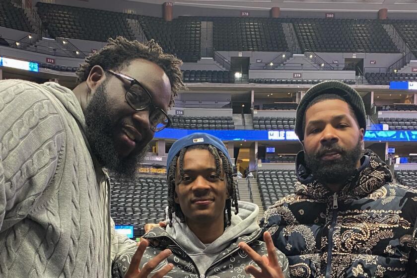 Skip Robinson (left) poses for a photo with Clippers teammates Bones Hyland (center) and Marcus Morris Sr.