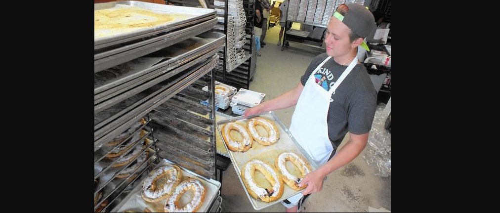 Employee Dustin Woodward prepares to stack a tray of kringles at Larsen’s Bakery. This batch is bound for a Wisconsin chain of supermarkets.