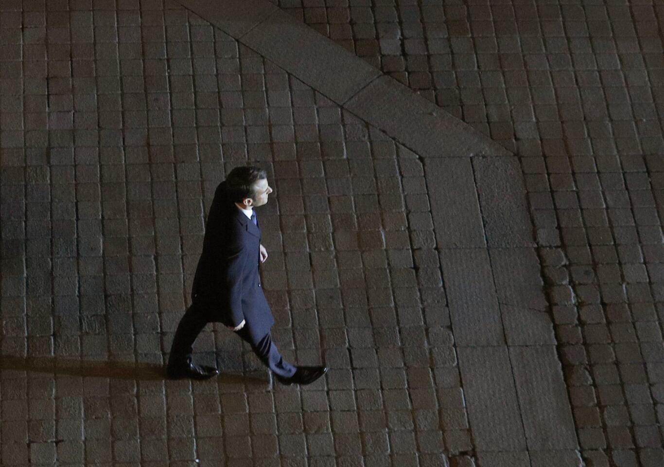 Incoming French President Emmanuel Macron walks towards the stage to address his supporters at the Louvre Palace in Paris, Sunday May 7, 2017. Polling agencies have projected that centrist Macron will be France's next president, putting a 39-year-old political novice at the helm of one of the world's biggest economies and slowing a global populist wave. (AP Photo/Christophe Ena, Pool)