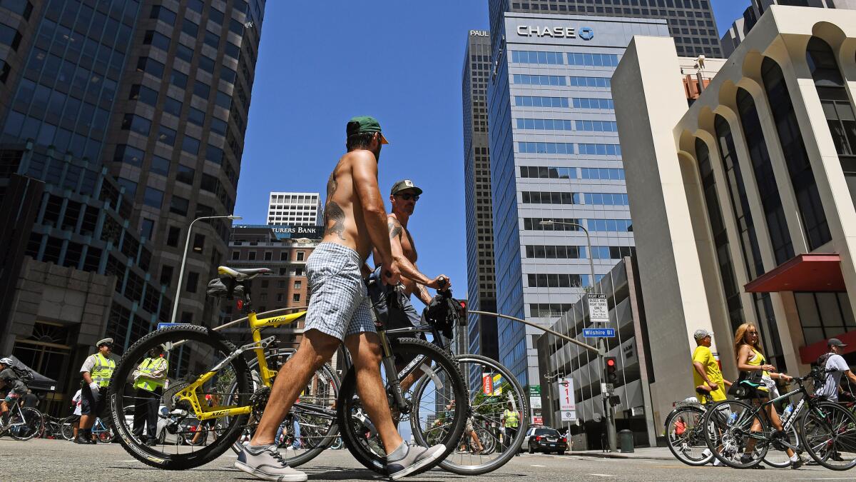 CicLAvia participants walk in the heat in downtown Los Angeles on Sunday.