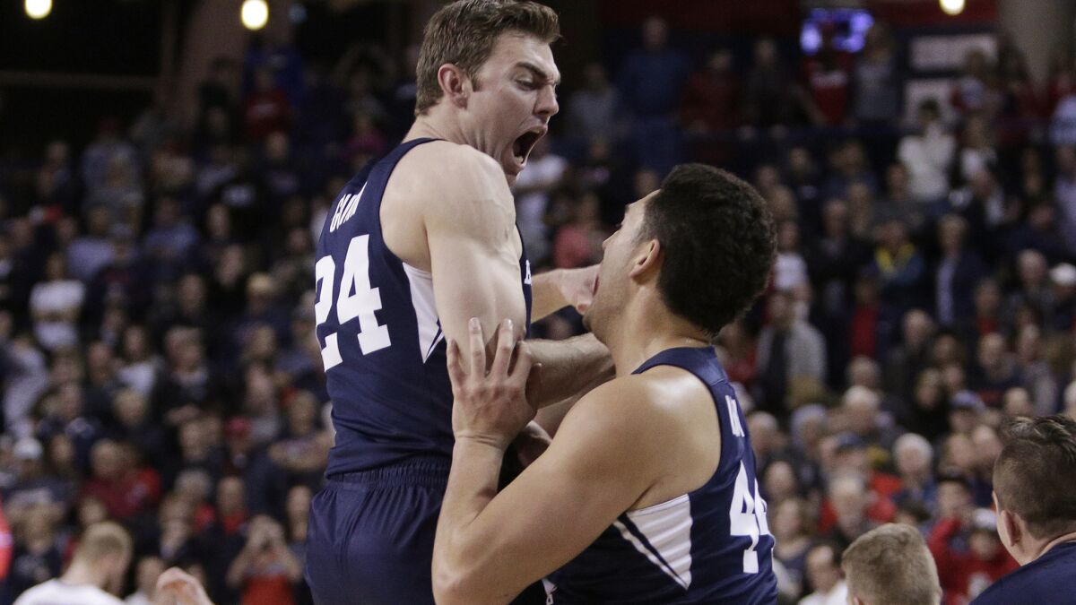 BYU forward Davin Guinn, left, and center Corbin Kaufusi celebrate after defeating top-ranked Gonzaga on Saturday night.