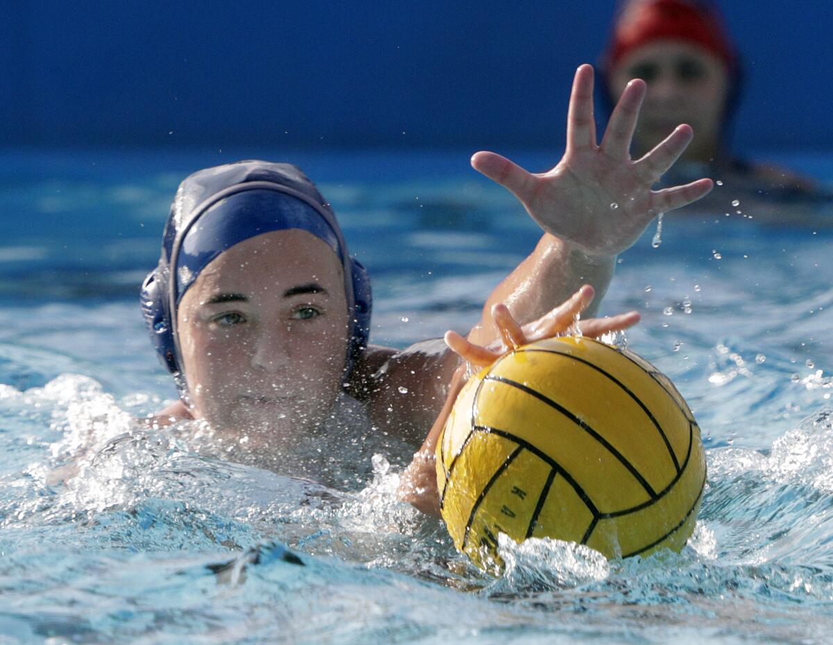 Flintridge Prep's Makena Walklett reaches for the ball as Mark Keppel's Amanda Cheung attempts to keep it out of distance in the CIF Southern Section Division VI semifinal girls' water polo playoff at Polytechnic School in Pasadena on Wednesday, February 19, 2020.