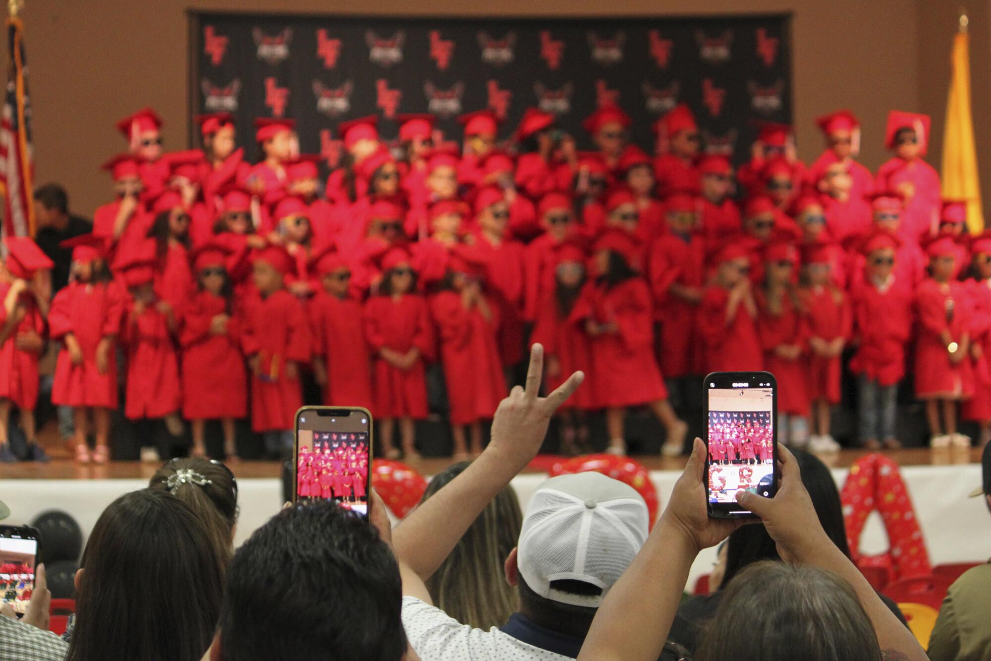 Family and friends take photos of kindergartners