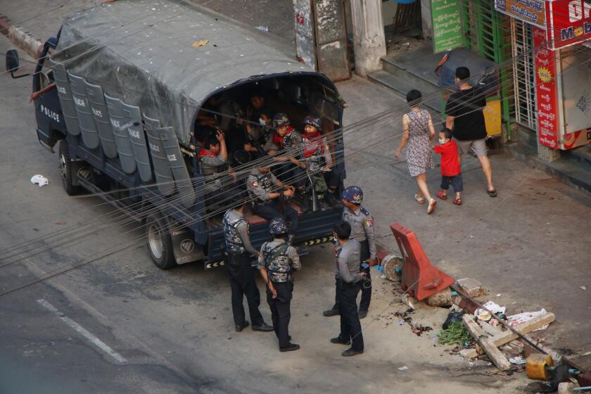 Security forces stand by on Hledan road in Kamayut township of Yangon in Myanmar, Monday, March 29, 2021. Over 100 people across the country were killed by security forces on Saturday alone, including several children. Myanmar aircraft also carried out three strikes along the country's border overnight Sunday, according to a member of the Free Burma Rangers, a humanitarian relief agency that delivers medical and other assistance to villagers. (AP Photo)
