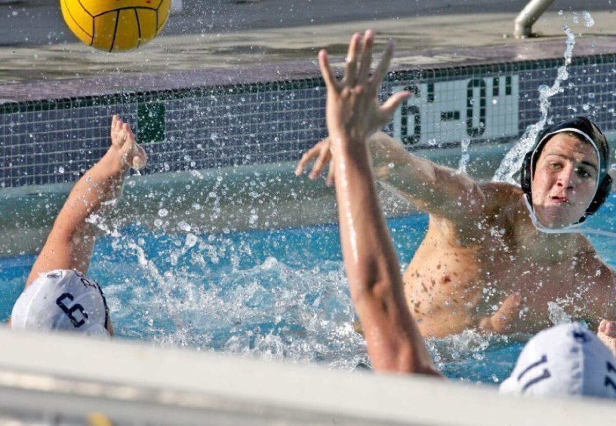 Hoover's Hakop Kaplanyan makes a goal attempt past Flintridge Prep's Kevin Matthews and Garrett Wat on Monday, October 26, 2009.