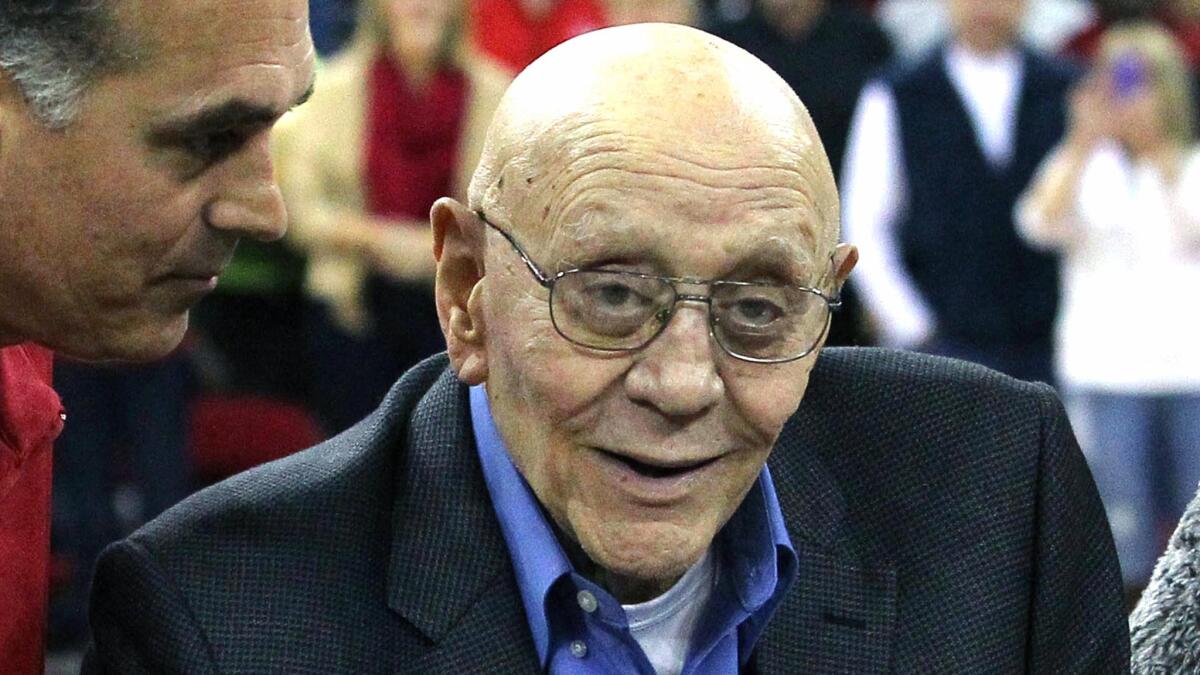 Jerry Tarkanian is escorted by his son, Danny, during a halftime ceremony in his honor at Fresno State on March 1, 2014.