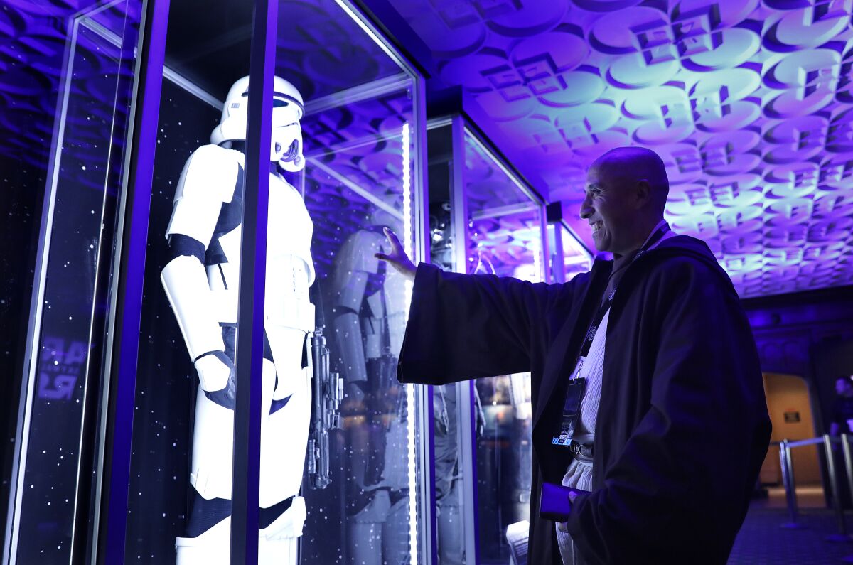 Christopher Duarte, 55, of Barstow, checks out a costume exhibit during a “Star Wars” marathon at the El Capitan Theatre in Hollywood, culminating in the premiere of “The Rise of Skywalker” on Thursday, December 19, 2019.