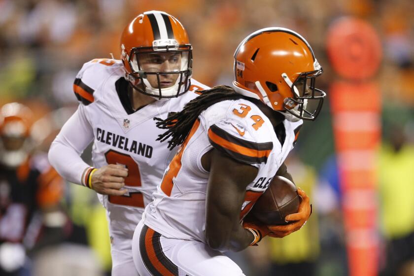 Cleveland running back Isaiah Crowell takes the handoff from quarterback Johnny Manziel during the second half of a game against Cincinnati on Nov. 5.