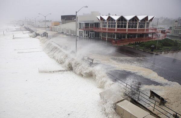 Waves and storm surge pound the boardwalk and the beach at first light as Hurricane Irene slams into Asbury Park, N.J. on Aug. 28.