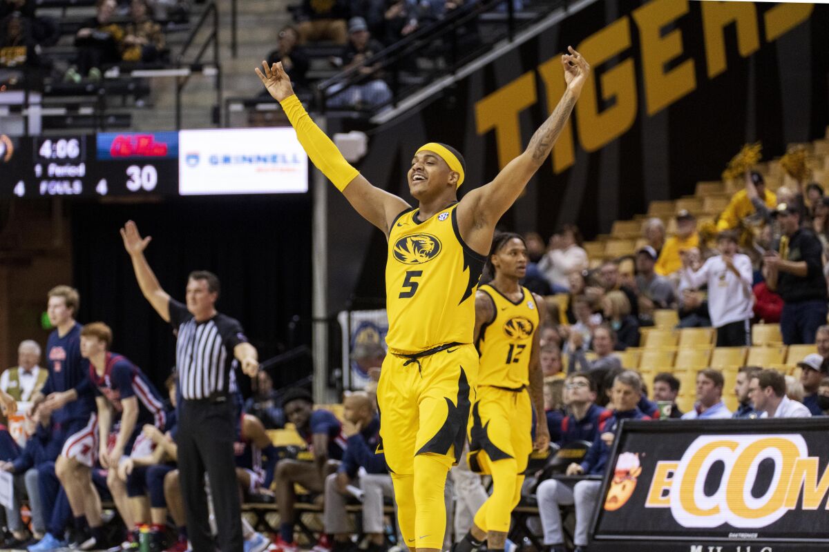 Missouri's Jarron Coleman (5) celebrates a 3-point basket during the first half of the team's NCAA college basketball game against Mississippi on Saturday, Feb. 12, 2022, in Columbia, Mo. (AP Photo/L.G. Patterson)