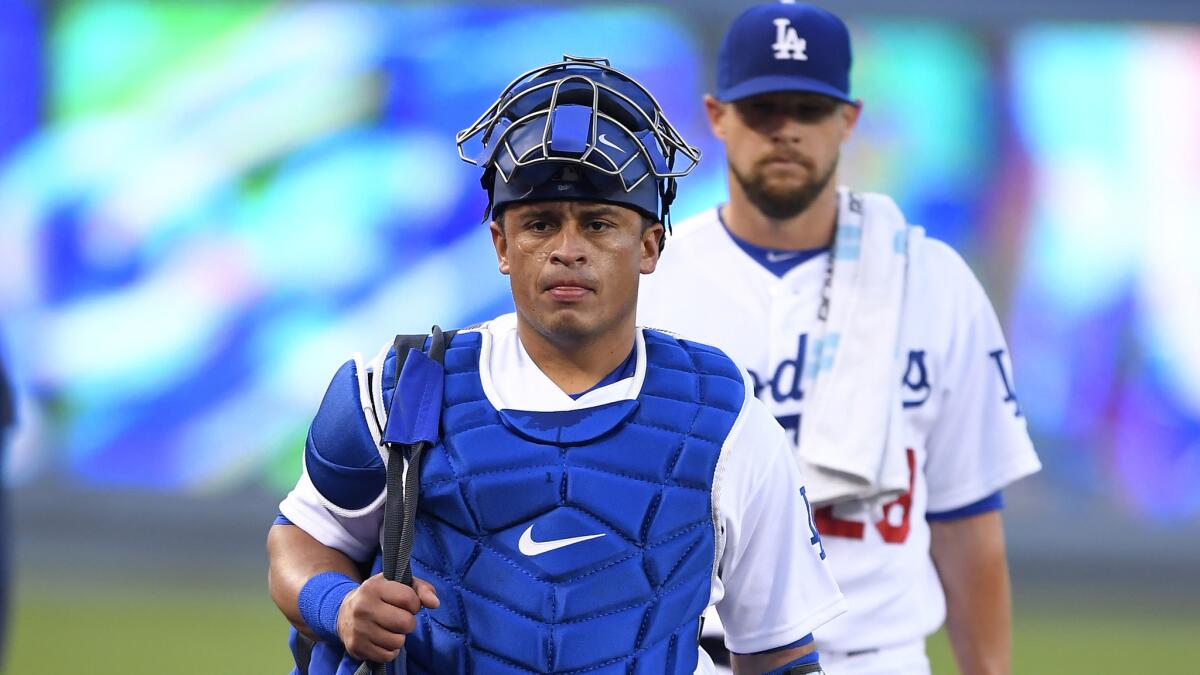 Newly acquired catcher Carlos Ruiz heads to the Dodgers' dugout before a game against the Cubs on Friday.