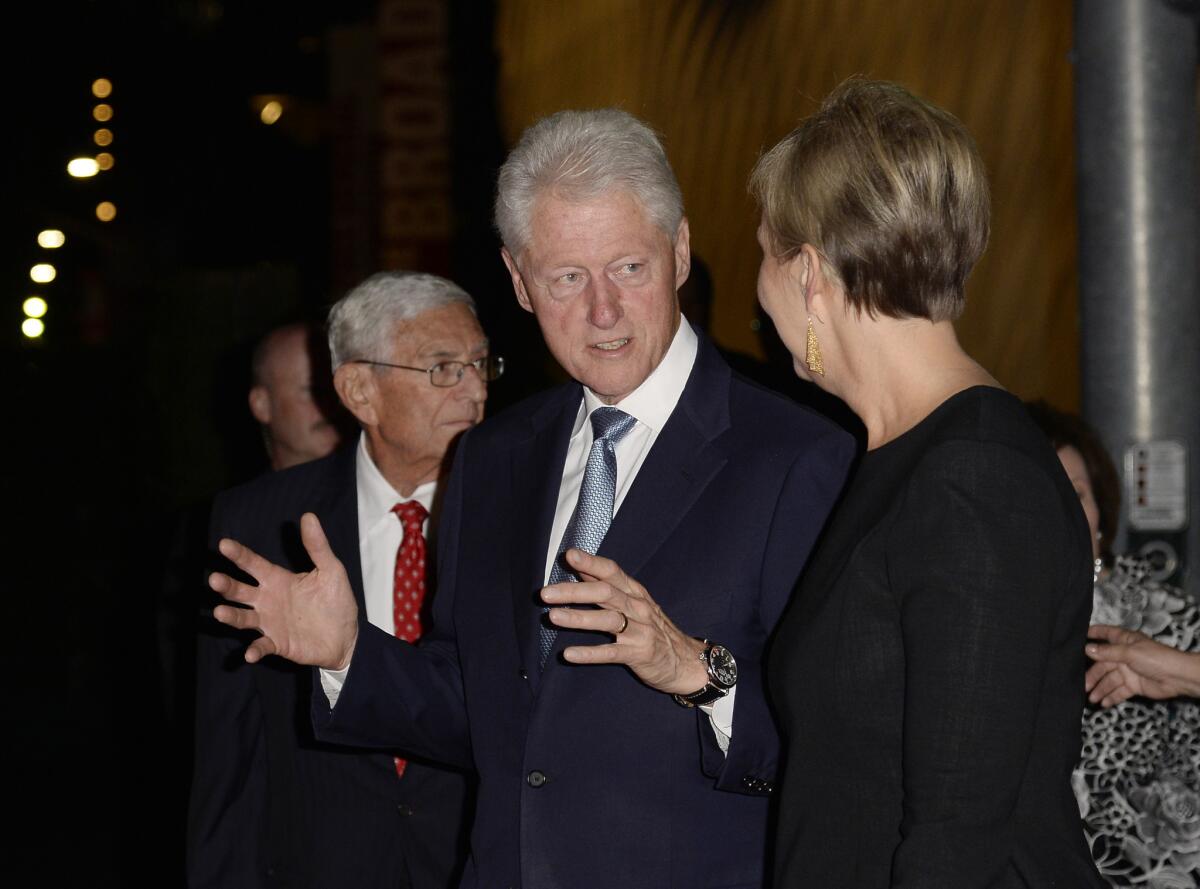 Former President Clinton stands with Joanne Heyler and Eli Broad during the Broad museum's party on Sept. 18.