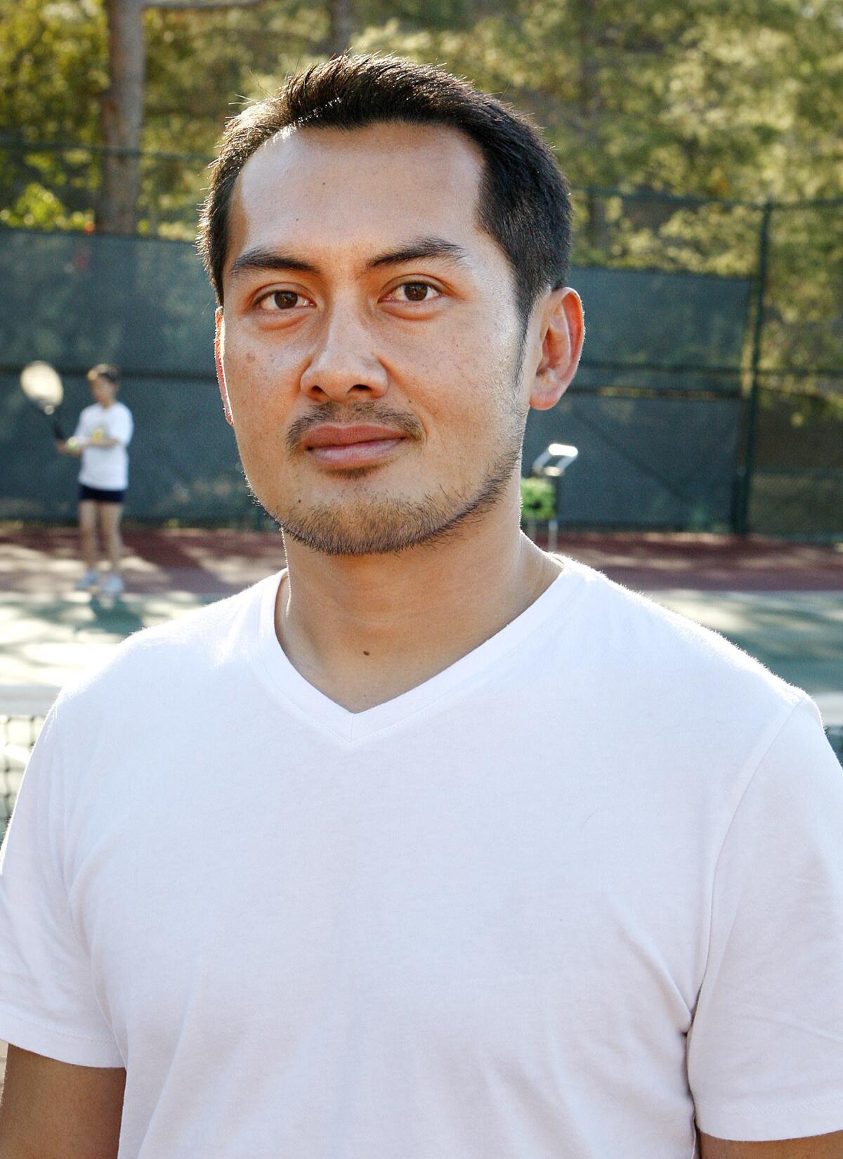 Deo Sy, first year head coach of GCC's women's tennis at practice on the GCC tennis courts on Wednesday, Jan. 15, 2014.