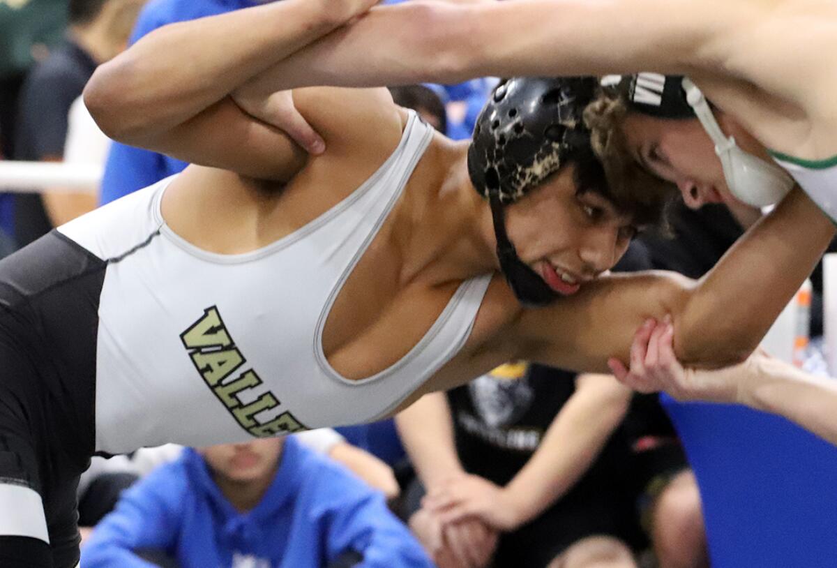 Fountain Valley's Hercules Windrath, left, seen on Jan. 13, won three matches to advance to the quarterfinals Thursday.