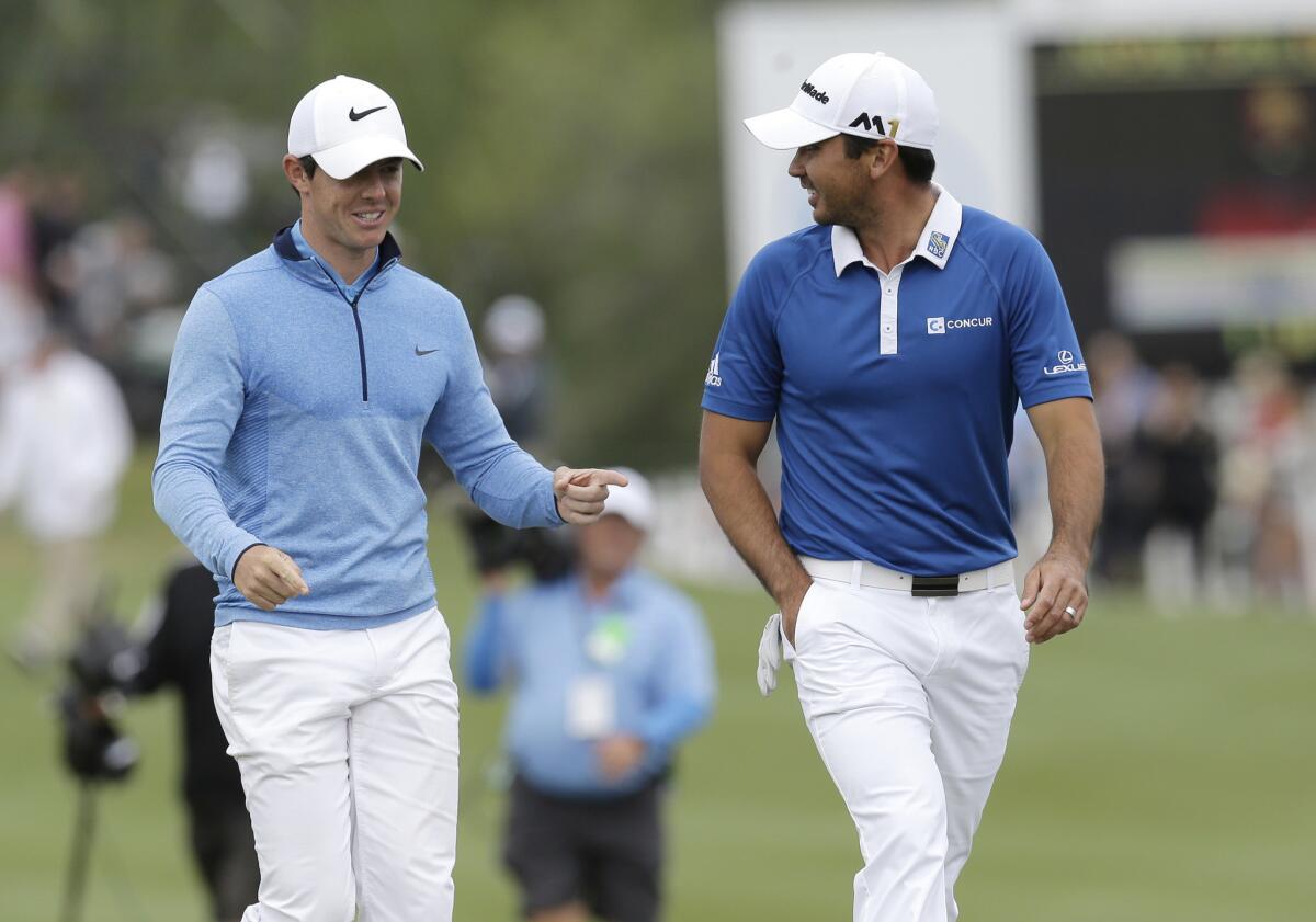 Rory McIlroy, left, and Jason Day walk to the 13th green during the semifinal round at the Dell Match Play Championship golf tournament at Austin County Club.