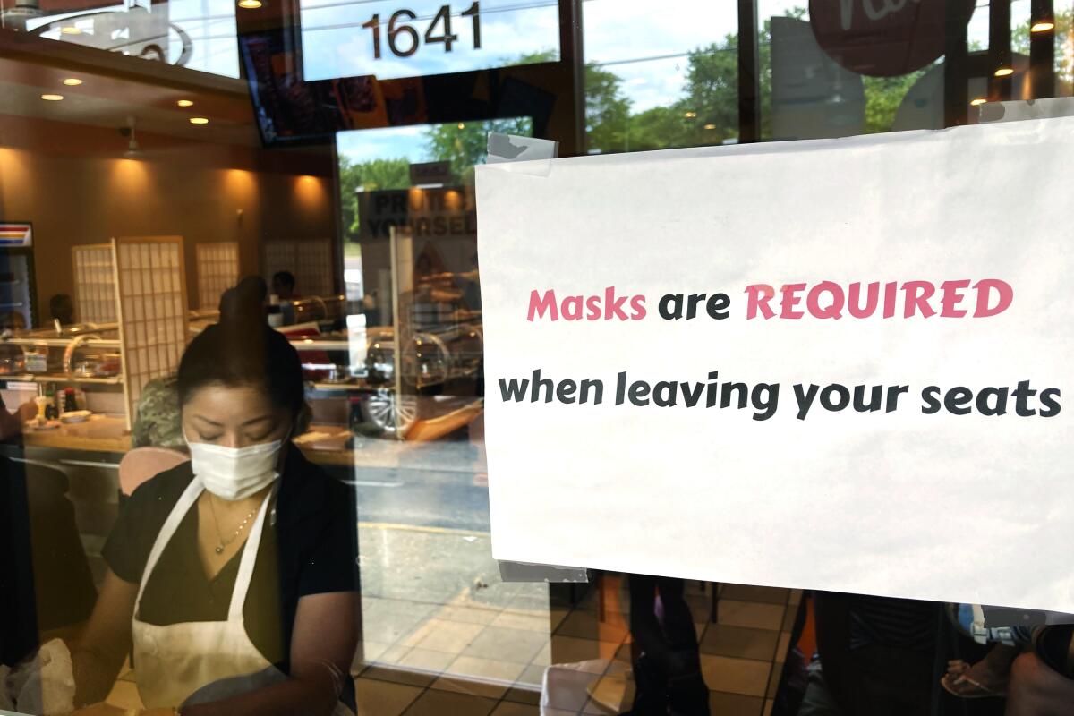 FILE - In this June 17, 2021 file photo, a sign is displayed at a restaurant in Rolling Meadows, Ill. The Institute for Supply Management said Tuesday, July 6 growth in the services sector, where most Americans work, slowed in June following record expansion in May. (AP Photo/Nam Y. Huh, File)