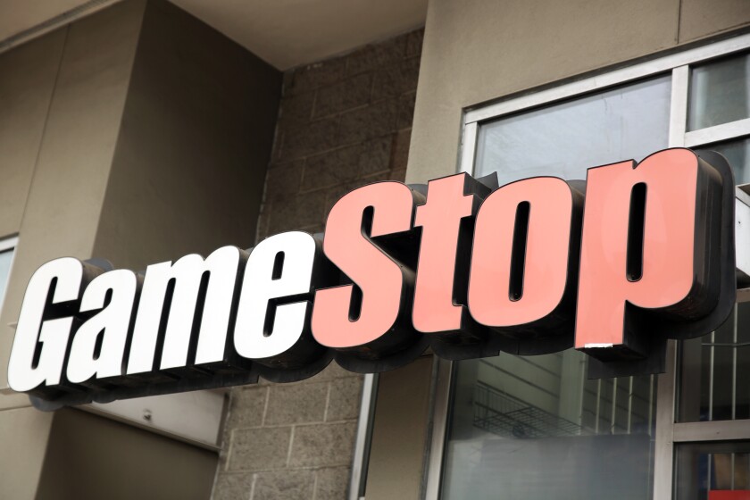 The GameStop sign above a store.