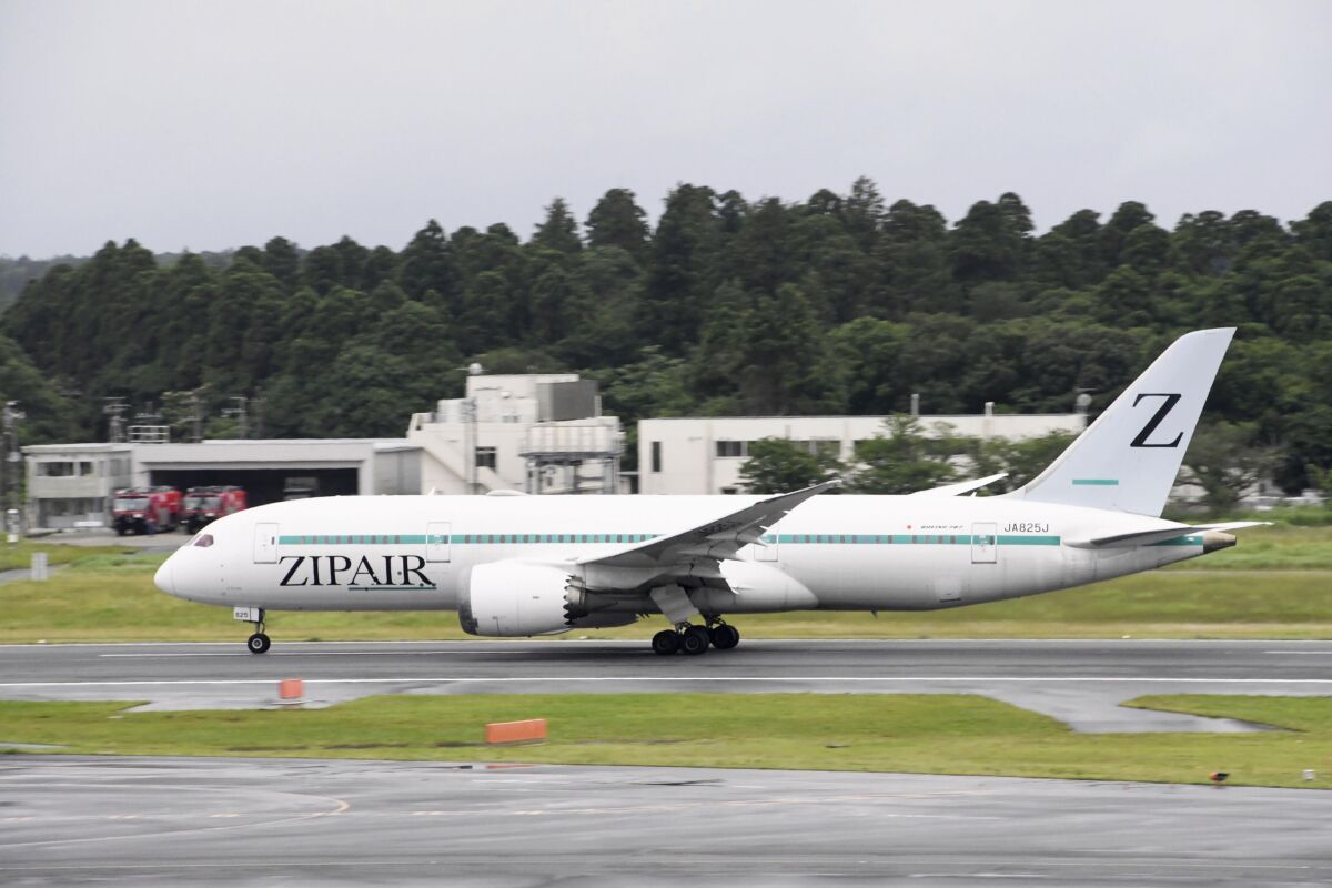 This photo shows an airplane of Japanese low-cost carrier Zipair at Narita Airport in Narita, near Tokyo June 15, 2022. The carrier is changing the design on its tail from the letter "Z," which resembles the symbol on Russian tanks. (Kyodo News via AP)