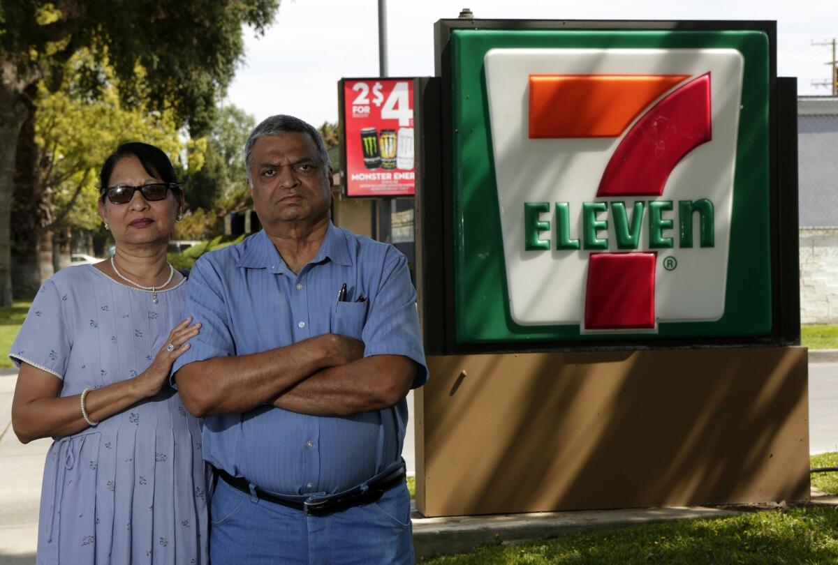 A group says it represents more than 1,200 franchisees who are accusing 7-Eleven of racial discrimination, invasion of privacy and illegal surveillance and mistreatment. Above, Saroj Patel, left, and her husband, Dilip, say 7-Eleven stripped them of the Riverside store they had run since 1995.