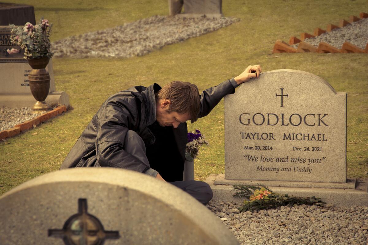 A man mourning at a grave