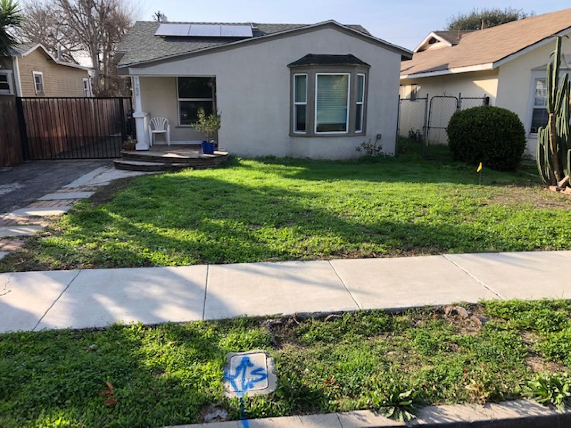 A modest home and a green lawn