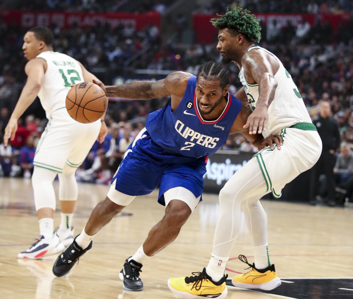 Kawhi Leonard drives against Boston's Marcus Smart during the second half.