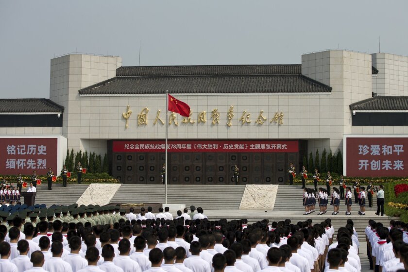 Liu Yunshan, left, a member of the Standing Committee of the Political Bureau of the Communist Party of China, delivers a speech at the opening ceremony of the Museum of the War of Chinese People's Resistance Against Japanese Aggression commemorating the World War II victory over Japan, in Beijing Tuesday, July 7, 2015. Soldiers and children stood in silence outside the museum at the opening ceremony for the "Great Victory and Historical Contribution" exhibition on the 78th anniversary of the Marco Polo Bridge Incident. A clash at the Marco Polo Bridge in 1937 is regarded as the first battle of the second Sino-Japanese war, which lasted until Japan's defeat by the Allies in 1945. (AP Photo/Andy Wong)