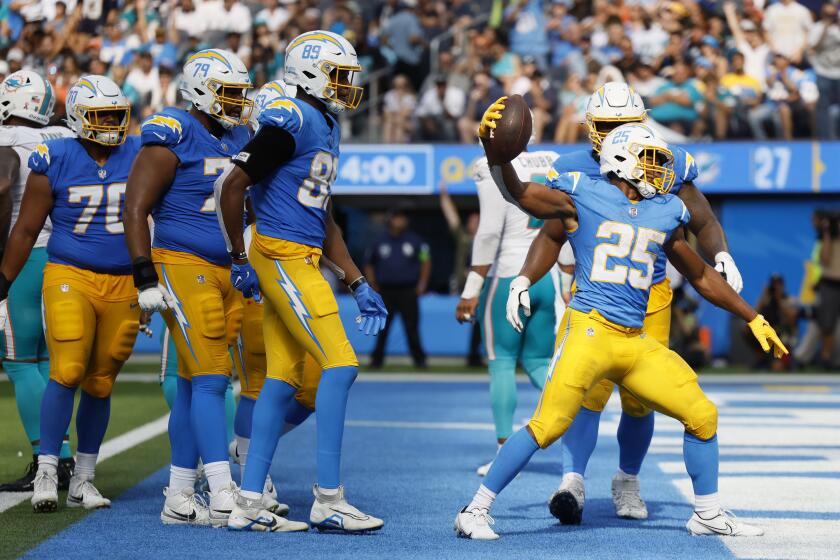  Chargers running back Joshua Kelley (25) celebrates after scoring a second-half touchdown against the Dolphins.