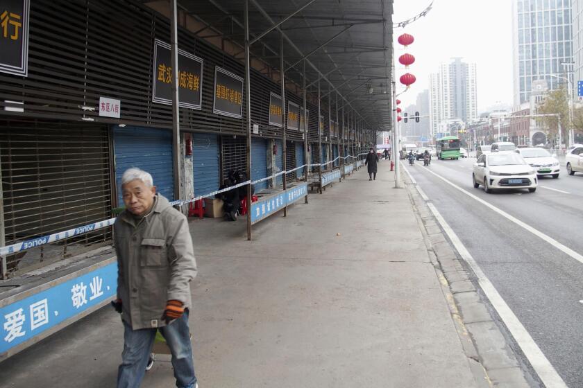 This Jan. 17, 2020, photo, shows the closed Huanan Seafood Wholesale Market in Wuhan, China. China reported Monday, Jan. 20 a sharp rise in the number of people affected in a pneumonia outbreak caused by a new coronoavirus, including the first cases in the capital. (Kyodo News via AP)