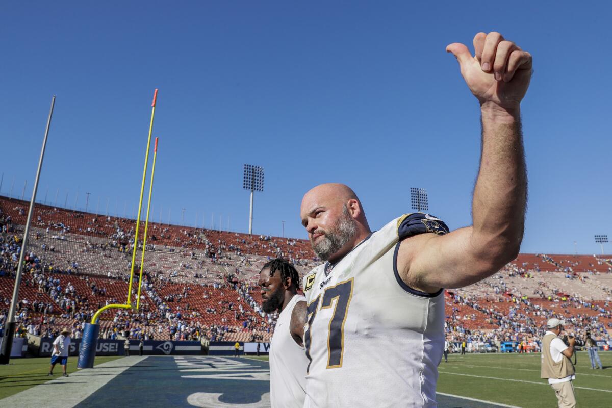 Rams tackle Andrew Whitworth gestures to fans after a 35-23 win over the Chargers at the Coliseum on Sept. 23, 2018.