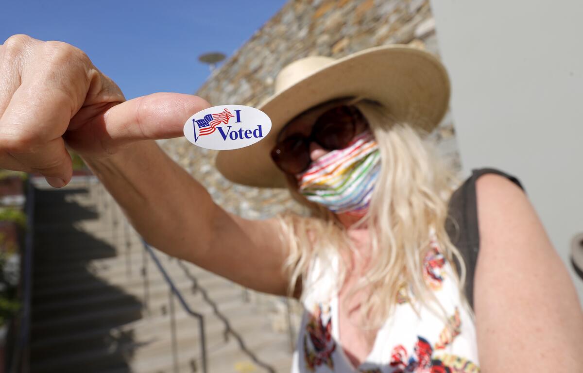 Voter Karen Petty shows off her "I voted" sticker at the Laguna Beach Community and Susi Q Center.