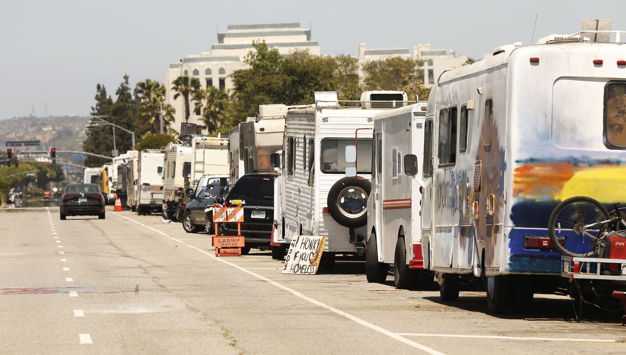 Campers are parked along West Jefferson Boulevard near the Ballona Wetlands.