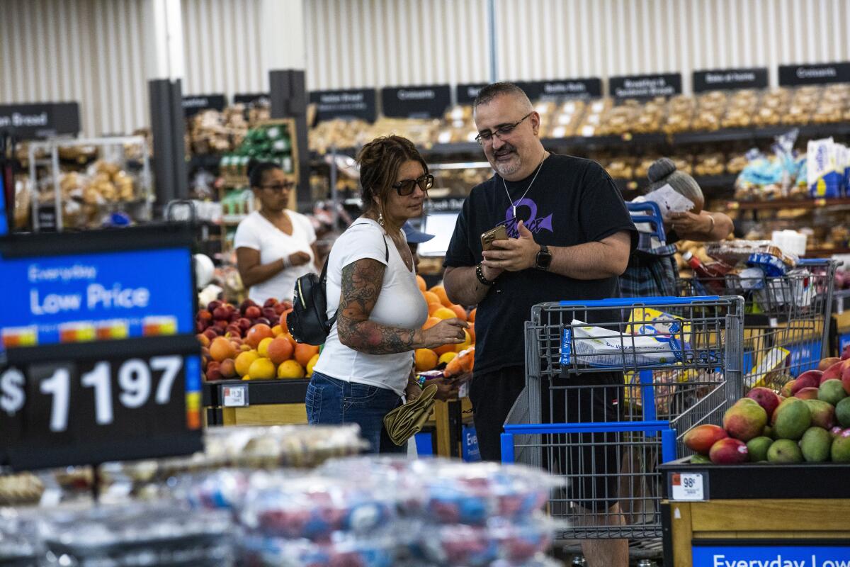 Shoppers pause in the produce section 