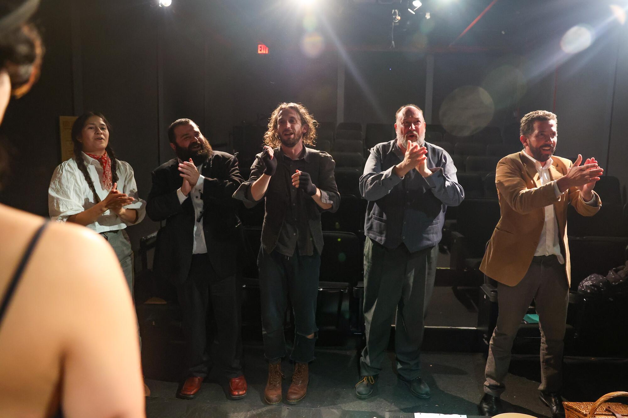 "Escape from Godot" The actors applaud the audience at the end of the play.