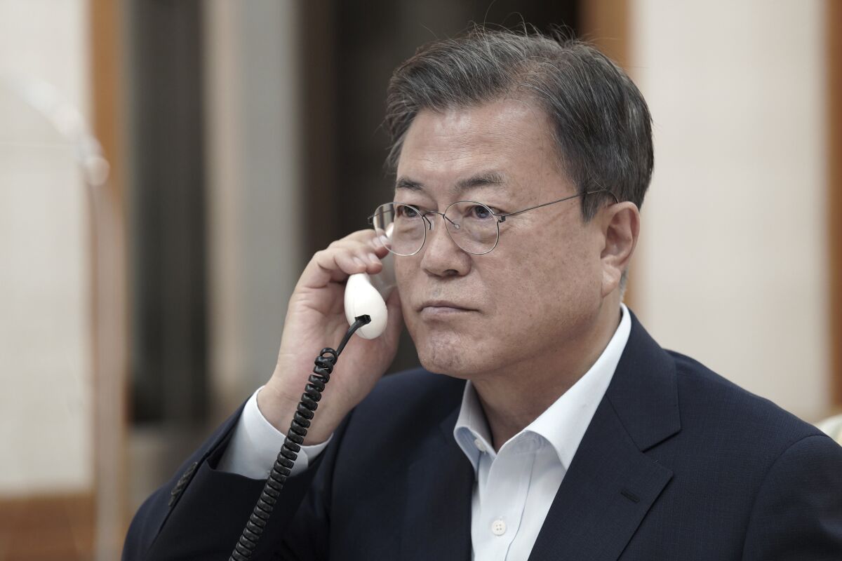 In this photo provided by South Korea Presidential Blue House via Yonhap News Agency, South Korean President Moon Jae-in talks on the phone with Japanese Prime Minister Fumio Kishida at the presidential Blue House in Seoul, South Korea, Friday, Oct.15, 2021. Leaders of Japan and South Korea held phone talks Friday and agreed on the importance to keep communicating despite their chilly relations strained over wartime Korean laborers' compensation and other disagreements on Japan's World War II atrocities. (South Korea Presidential Blue House/Yonhap via AP)