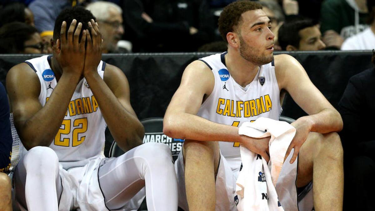 California's Kingsley Okoroh (22) and Kameron Rooks can barely stand to watch the closing moments of a loss to Hawaii on Friday.